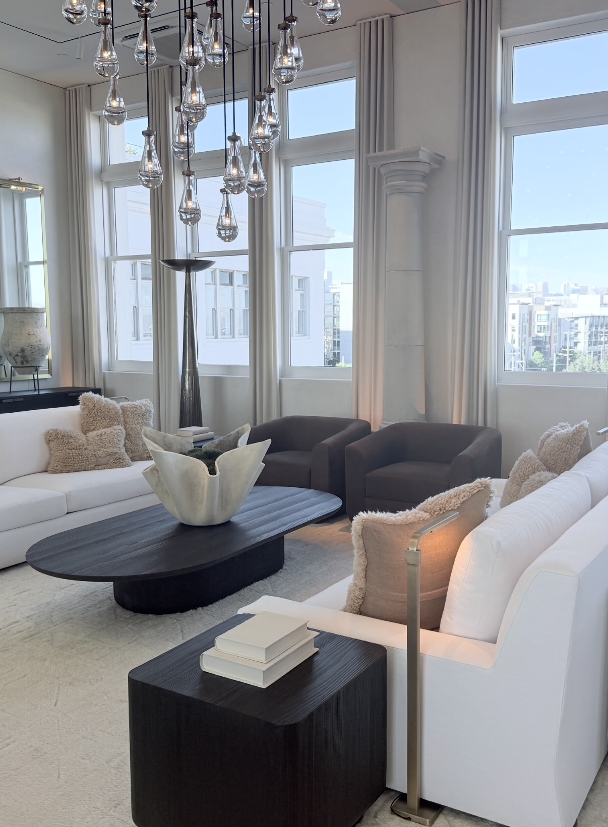 Bright reception room with large cream sofas